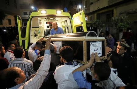 A coffin is carried out of an ambulance outside of the Coptic church that was bombed on Sunday in Tanta, Egypt, April 9, 2017. REUTERS/Mohamed Abd El Ghany
