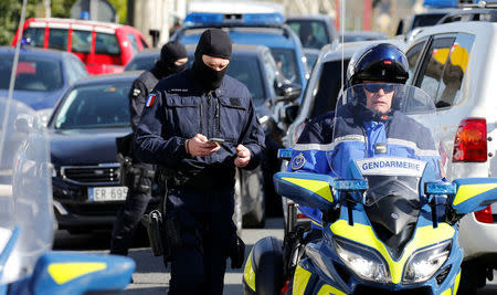 Gendarmes of the French special unit GIGN are seen next to a supermarket after a hostage situation in Trebes, France, March 23, 2018. REUTERS/Regis Duvignau