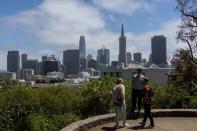 Tourists look over downtown San Francisco including the Transamerica Pyramid building in California