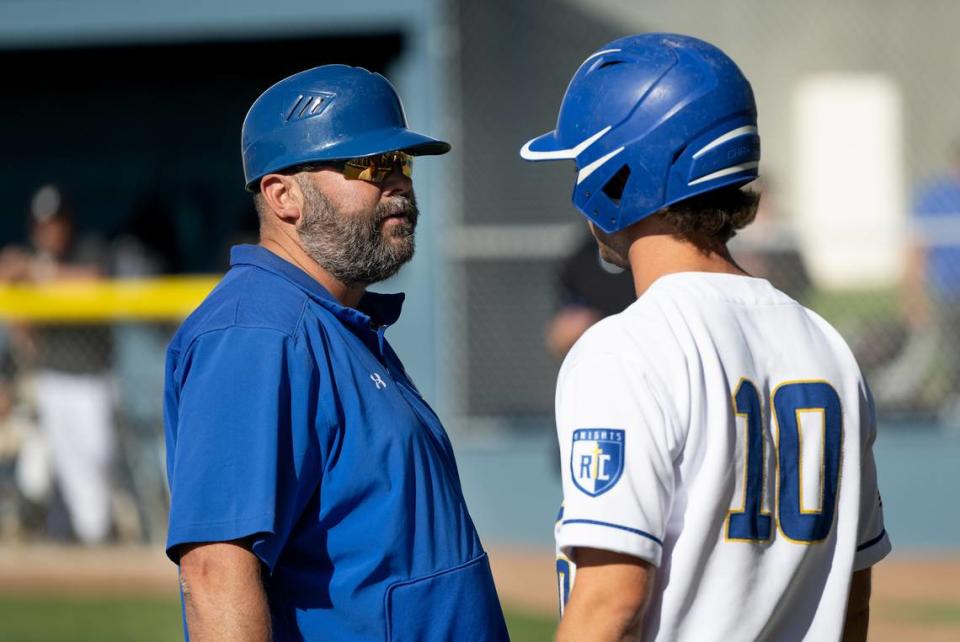 Ripon Christian coach John de Visser, left, talks with Dustin Hoekstra during the Sac-Joaquin Section Division VI playoff game with Millennium of Tracy in Ripon, Calif., Wednesday, May 8, 2024.