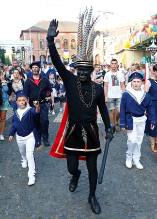 "The Savage", a white performer in a blackface disguise, waves during the festival Ducasse d'Ath in Ath