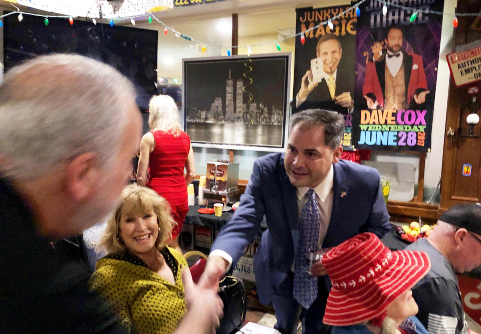 FILE - In this Jan. 28, 2020 file photo, 25th District congressional candidate and former Navy combat pilot Mike Garcia greets supporters in Simi Valley, Calif. The fight for an open U.S. House seat in a swing district north of Los Angeles provides Republicans with a rare opportunity to gain ground in heavily Democratic California, and the outcome could send a message about where voters place their trust during the coronavirus crisis. The toss-up contest between Republican Garcia and Democrat Christy Smith will inevitably be seen as a proxy vote on President Donald Trump’s leadership during the crisis. (AP Photo/Michael Blood,File)