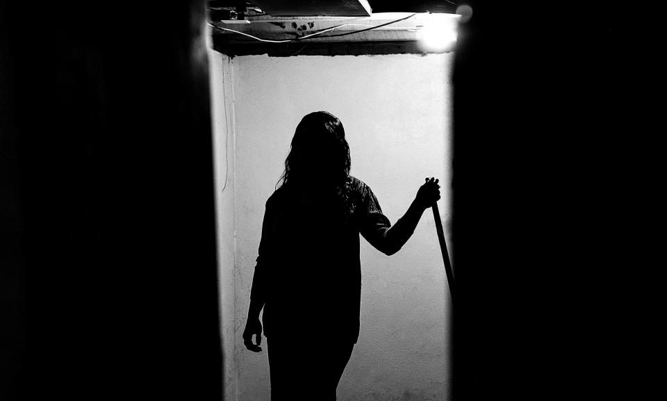 Kwmisha Adams stands in the empty basement of her residence on Lindell Avenue in Louisville's Shawnee neighborhood. The house was built in the 1920s and has tested positive for lead paint on the front door frame, kitchen windowsill and other areas in the home. Adams is concerned about how exposure to lead could affect her five children. Oct. 10, 2023