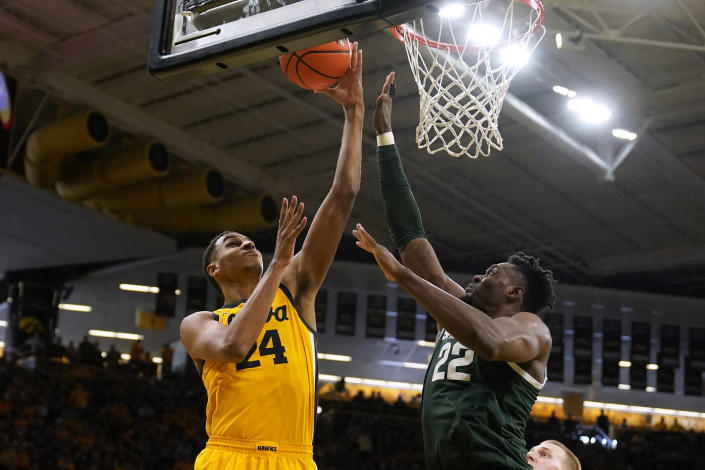 Iowa forward Kris Murray (24) drives to the basket over Michigan State center Mady Sissoko (22) during the second half of an NCAA college basketball game, Saturday, Feb. 25, 2023, in Iowa City, Iowa. (AP Photo/Charlie Neibergall)