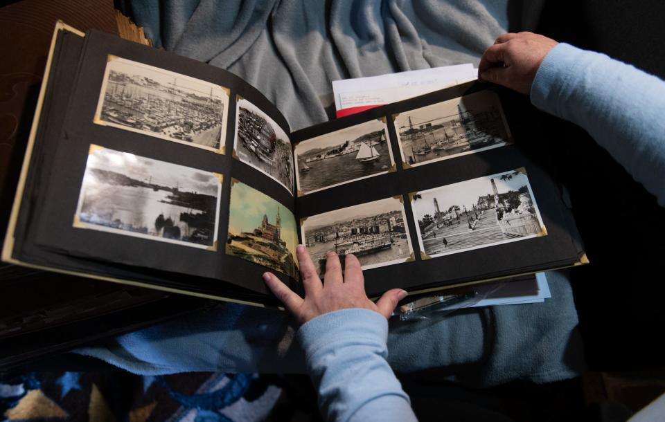 Jana Nicol, of Lansing, shows photo albums of her late father Duane Nicol's travels abroad, during his time as a World War II Navy veteran. He served in both the Pacific and Atlantic theaters. Jana, now 60, has spent the past two years transcribing her father's journal, photo albums, and more than 300 letters sent home during WWII.