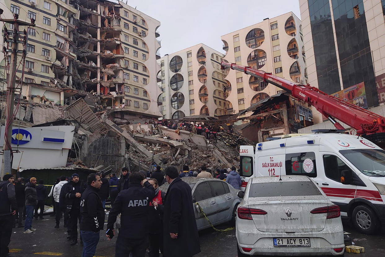 Rescue workers and medical teams try to reach trapped residents in a collapsed building following an earthquake in Diyarbakir, southeastern Turkey, early Monday, Feb. 6, 2023. A powerful earthquake has caused significant damage in southeast Turkey and Syria and many casualties are feared. Damage was reported across several Turkish provinces, and rescue teams were being sent from around the country. (AP Photo/Mahmut Bozarsan)