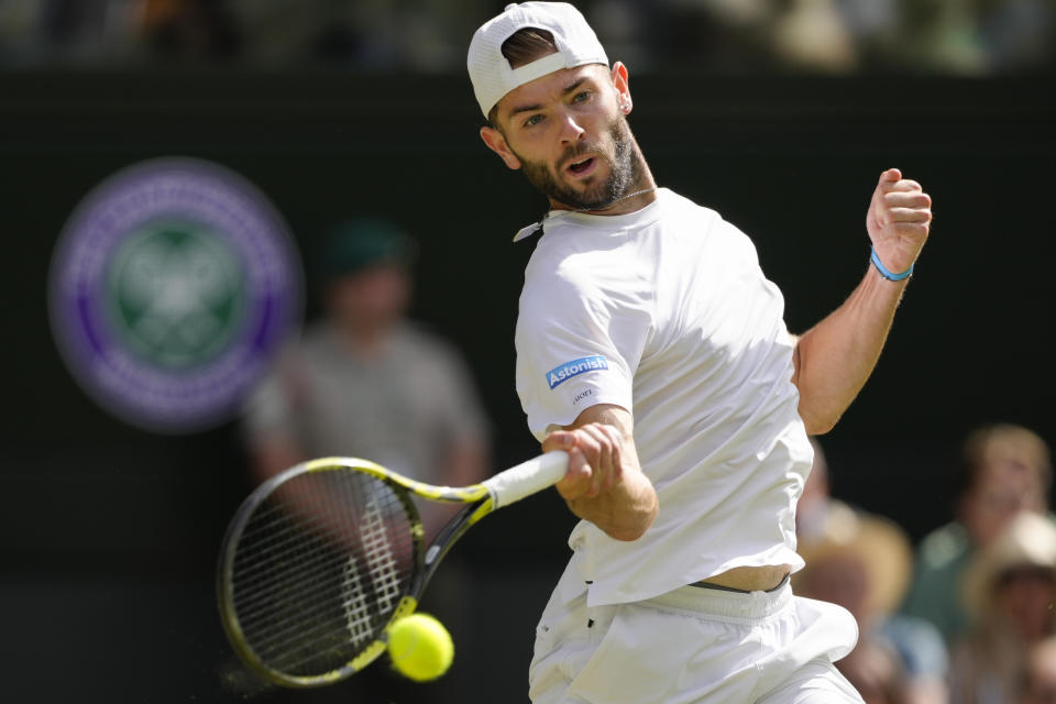 Supporters of Britain's Jacob Fearnley plays a forehand return during his second round match against Serbia's Novak Djokovic at the Wimbledon tennis championships in London, Thursday, July 4, 2024. (AP Photo/Kirsty Wigglesworth)