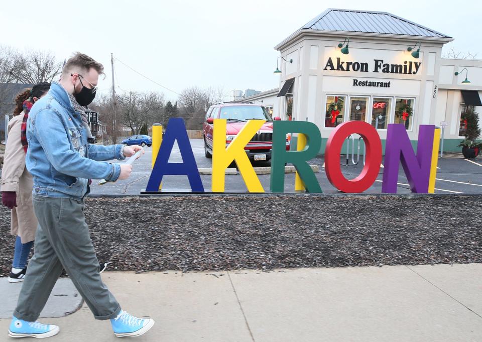 Fran Wilson and Nahla Bendefaa of the West Hill Neighborhood Organization head to Akron Family restaurant to leave a flyer and bus passes for anyone who might need them.