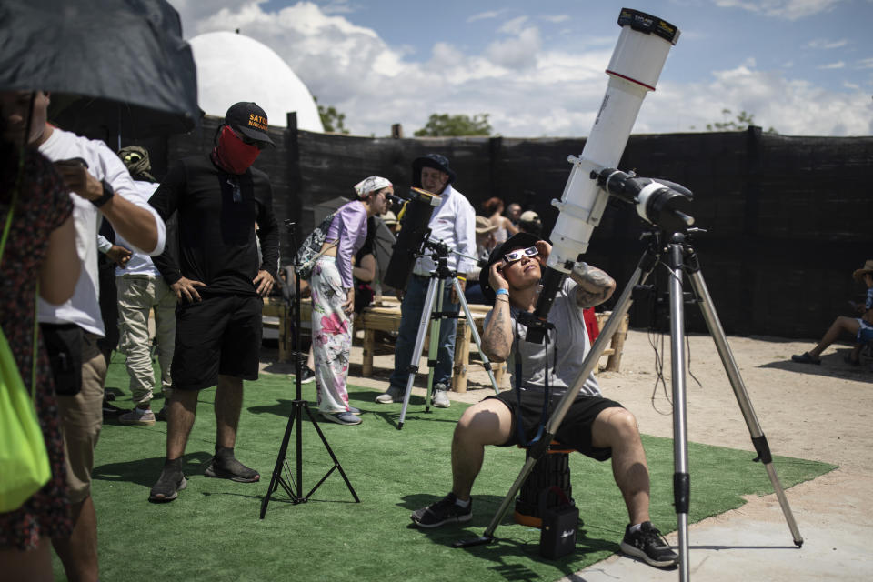 People watch a "ring of fire" solar eclipse in Tatacoa Desert, Colombia, Saturday, Oct. 14, 2023. The annular eclipse dimmed the skies over parts of the western U.S. and Central and South America. (AP Photo/Ivan Valencia)