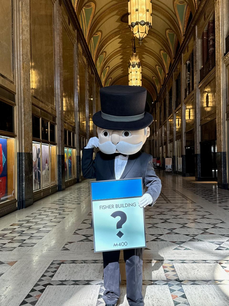 A picture of the Monopoly board game mascot Milburn Pennybags posing inside Detroit's Fisher Building as Hasbro plans its Detroit Edition Monopoly.
