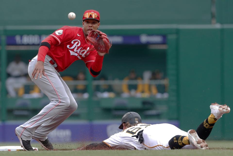 Pittsburgh Pirates center fielder Jack Suwinski steals second base as Cincinnati Reds shortstop Jose Barrero takes a late throw during the fourth inning.