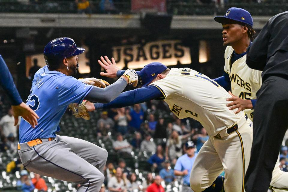 Milwaukee Brewers first baseman Rhys Hoskins (12) tries to separate Tampa Bay Rays center fielder Jose Siri (22) from pitcher Abner Uribe (45) during a brawl in the eighth inning Tuesday at American Family Field.
