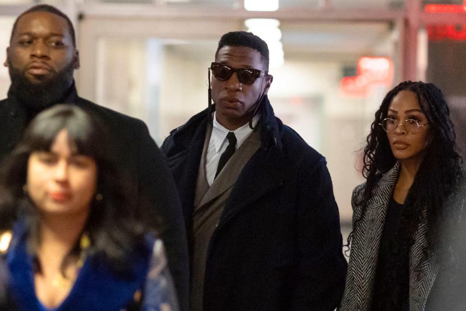 Majors, center, and Meagan Good, right, arrive at court for jury selection in Major's domestic violence case in New York. (AP)