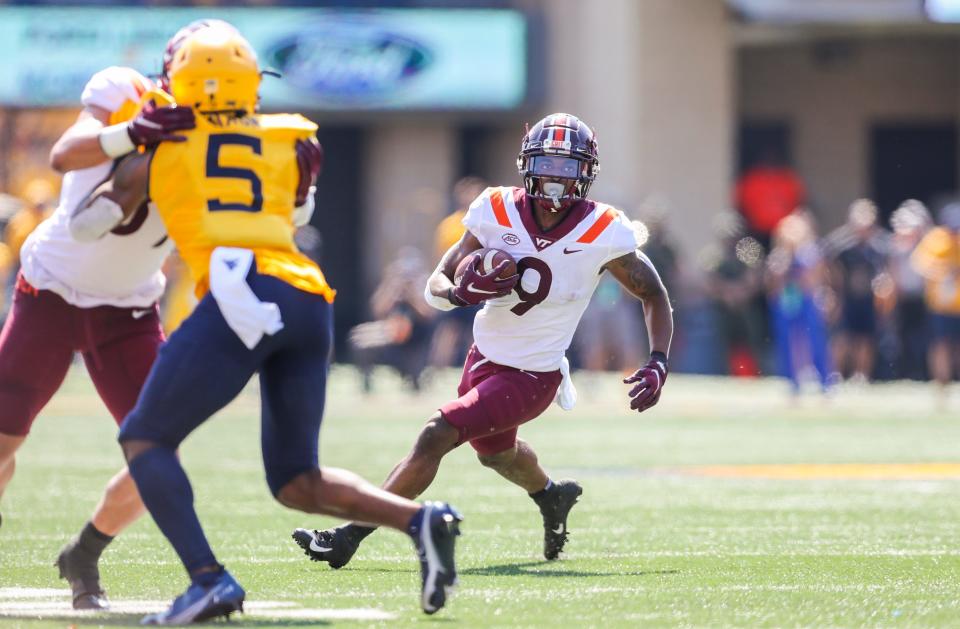 Sep 18, 2021; Morgantown, West Virginia, USA; Virginia Tech Hokies wide receiver Tayvion Robinson (9) runs after a catch during the second quarter against the West Virginia Mountaineers at Mountaineer Field at Milan Puskar Stadium.