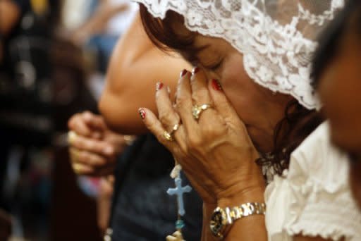 Dionisia Pacquiao (centre), mother of Philippine boxing icon Manny Pacquiao, prays at a church in General Santos City in Mindanao on June 10. A furious Dionisia Pacquiao led demands in the Philippines Monday for her dethroned boxing superstar son to have a rematch with Timothy Bradley, although church leaders said the Catholic fighter should retire