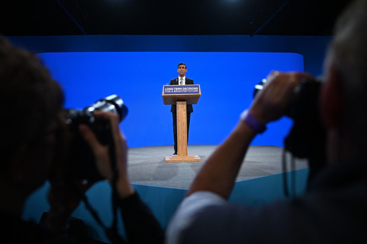TOPSHOT - Britain's Prime Minister Rishi Sunak addresses delegates at the annual Conservative Party Conference in Manchester, northern England, on October 4, 2023. (Photo by Oli SCARFF / AFP) (Photo by OLI SCARFF/AFP via Getty Images)