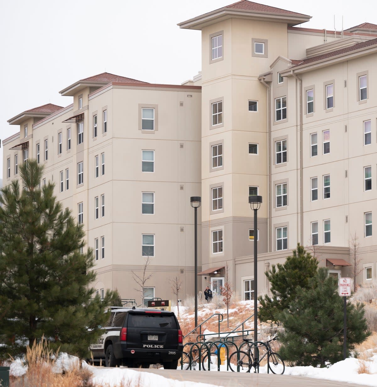 A police officer stands outside a dorm in the Village at Alpine Valley housing, Friday 16 February 2024, as police investigate a shooting on the University of Colorado Colorado Springs campus in Colorado Springs, Colo. (Christian Murdock/The Gazette via AP) ((Christian Murdock/The Gazette via AP))