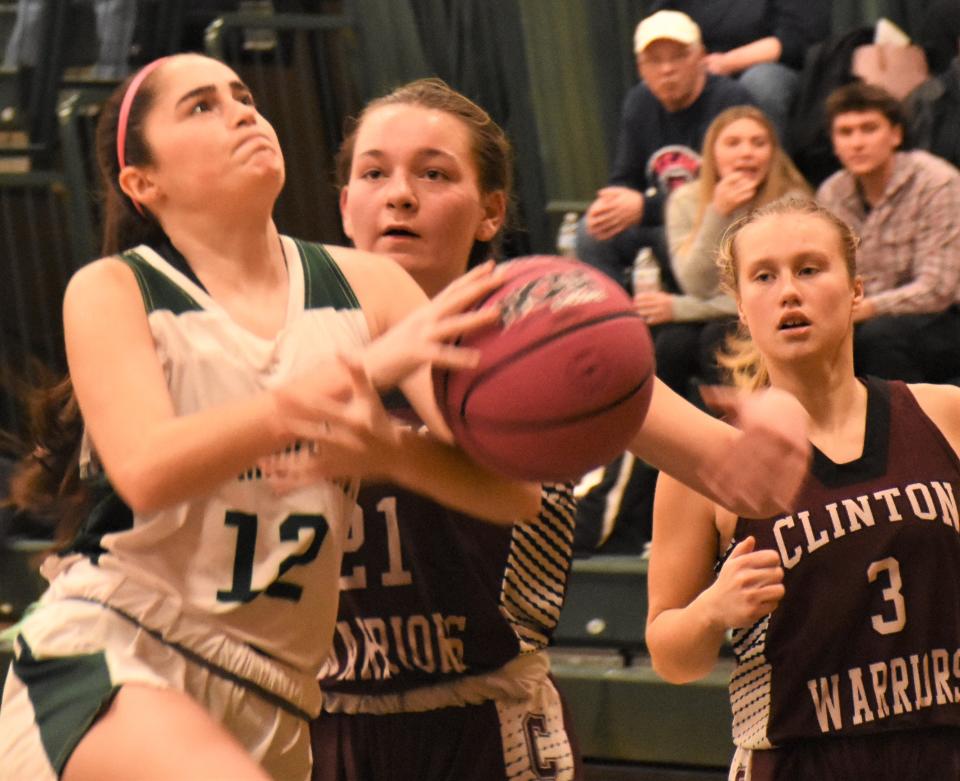 Westmoreland Bulldog Ella McGregor (12) draws a foul from Clinton Warrior Eva Gaetano Sunday during the Utica Board of Officials for Women's Basketball Cancer Challenge at Herkimer College.