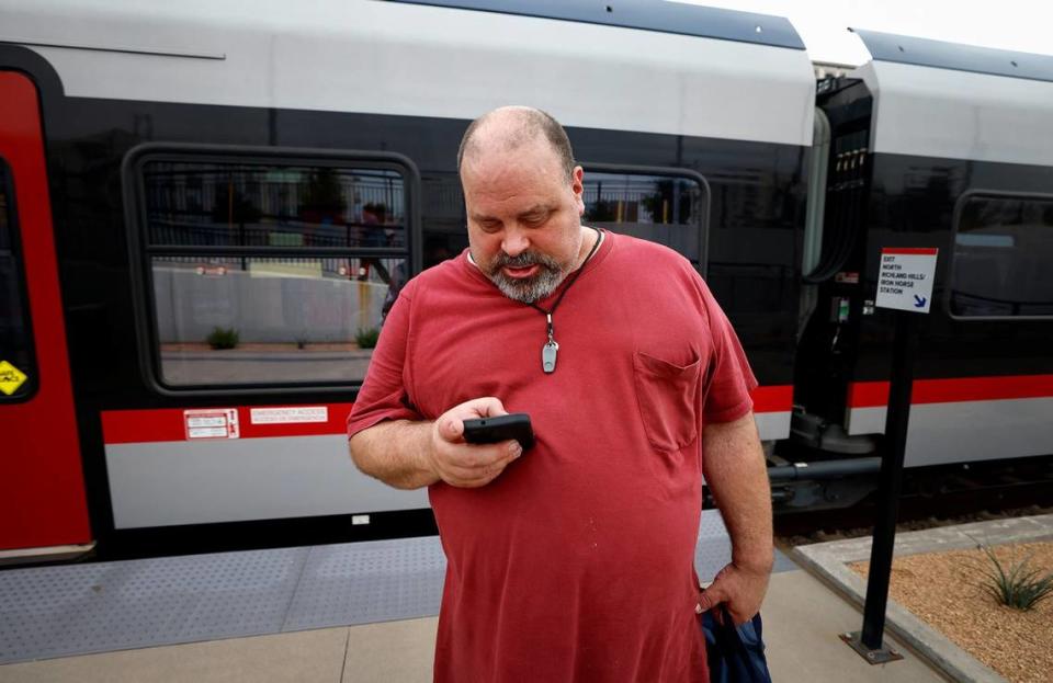 Billy Patton uses his phone to request an Uber to take him the last leg of his trip home in North Richland Hills after working at Lighthouse for the Blind on Wednesday, May 22, 2024.