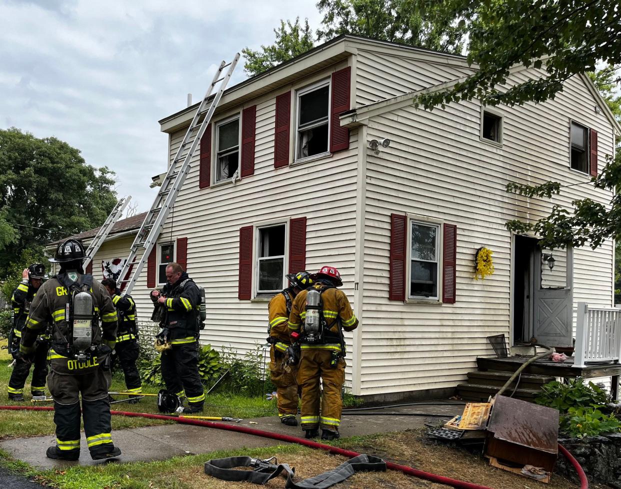 Firefighters assess fire damage to a home Logan Path in Grafton on Wednesday.