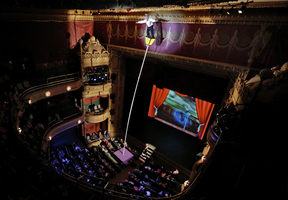 This March 23, 2013 photo shows performer Bello Nock perched atop a sway pole trying to retrieve an balloon, as he performs during his "Bello Mania" show, at the New Victory Theater in New York. Nock, a seventh-generation circus performer, is never offstage during the 90-minute performance, which combines slapstick clowning with death-defying aerial stunts. He performs through March 31 at the New Victory before moving on to the Canadian side of Niagara Falls and then a 10-week stint at the Beau Rivage Casino in Biloxi, Miss. (AP Photo/Richard Drew)