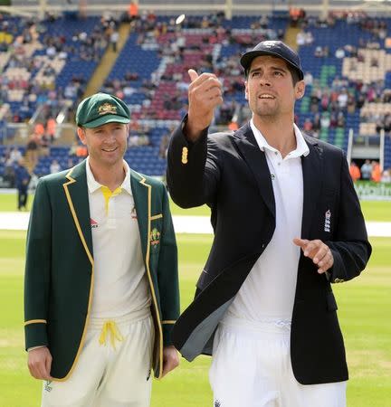 Cricket - England v Australia - Investec Ashes Test Series First Test - SWALEC Stadium, Cardiff, Wales - 8/7/15 England captain Alastair Cook tosses the coin watched by Australia captain Michael Clarke before the first Ashes test match. REUTERS/Philip Brown