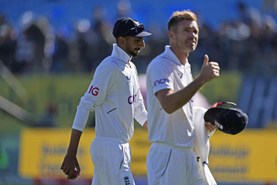 England's James Anderson gestures to the crowd as he walks with teammate Shoaib Bashir at the end of India's innings on the third day of the fifth and final test match between England and India in Dharamshala, India, Saturday, March 9, 2024. (AP Photo /Ashwini Bhatia)