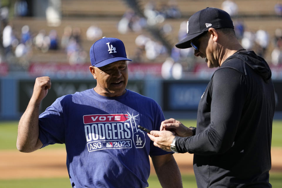 Los Angeles Dodgers manager Dave Roberts, left, talks with New York Yankees manager Aaron Boone prior to a baseball game Friday, June 2, 2023, in Los Angeles. (AP Photo/Mark J. Terrill)