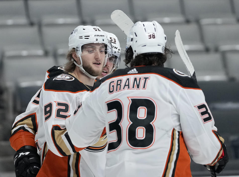 Anaheim Ducks right wing Alexander Volkov (92) is congratulated by Derek Grant (38) after scoring a goal against the San Jose Sharks during the second period of an NHL hockey game Wednesday, April 14, 2021, in San Jose, Calif. (AP Photo/Tony Avelar)