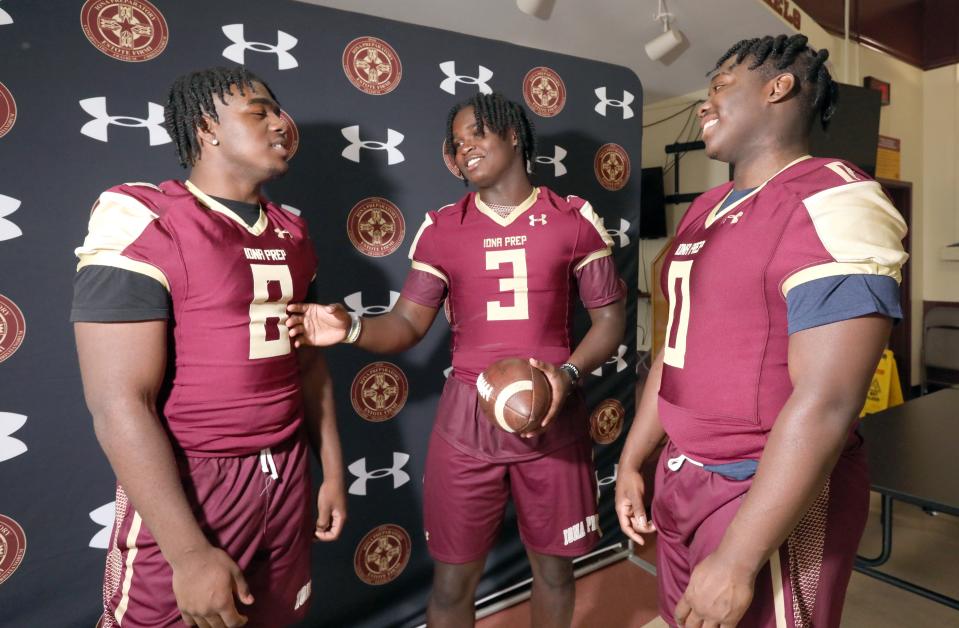 Iona Prep football players Zyian Moultrie-Goddard, left,  Ajani Sheppard and Capri Martin announce their college commitments June 27, 2022.