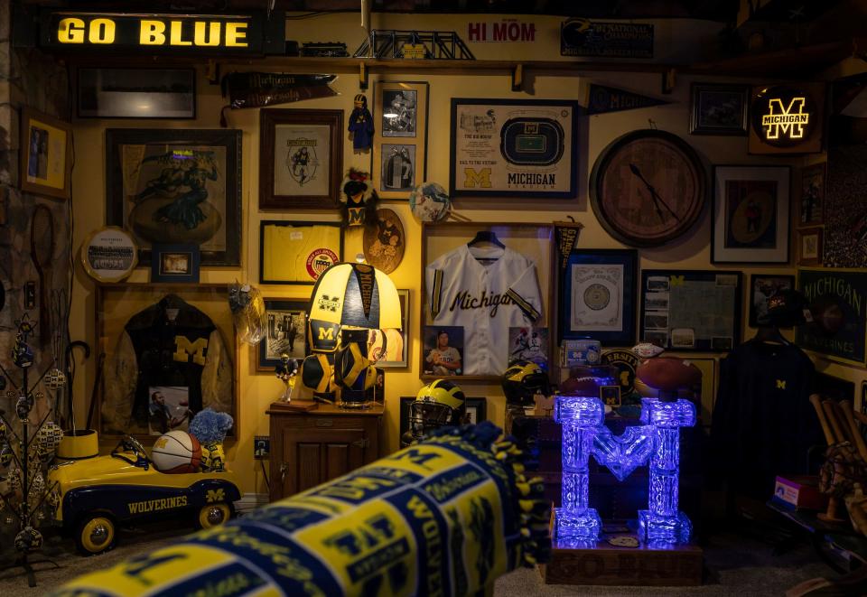 University of Michigan superfan and retired teacher Kenn Domerese, 73, has hundreds of pieces of University of Michigan memorabilia dating back to the 1870s inside his Fenton home.