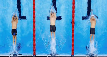 Ryan Murphy of USA (C) starts. REUTERS/Athit Perawongmetha