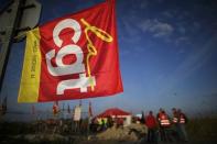 Striking French labour union employees stand near a barricade to block the entrance of the depot of the SFDM company near the oil refinery to protest the the governments proposed labor law reforms in Donges, France, May 26, 2016. REUTERS/Stephane Mahe