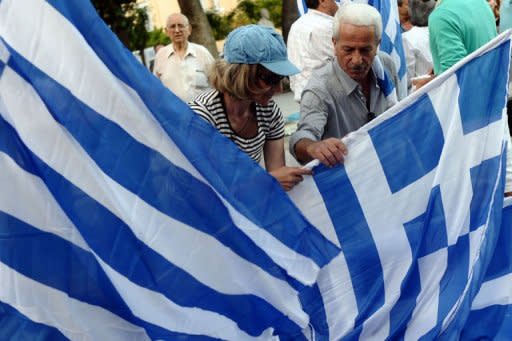 Supporters of Greek conservative party New Democracy distribute flags prior to a pre-election speech of their leader Antonis Samaras in Athens on May 3. Not only Greece but also Europe braced for an election that polls indicate will fail to produce a clear winner, and which markets worry will plunge the eurozone into fresh turmoil