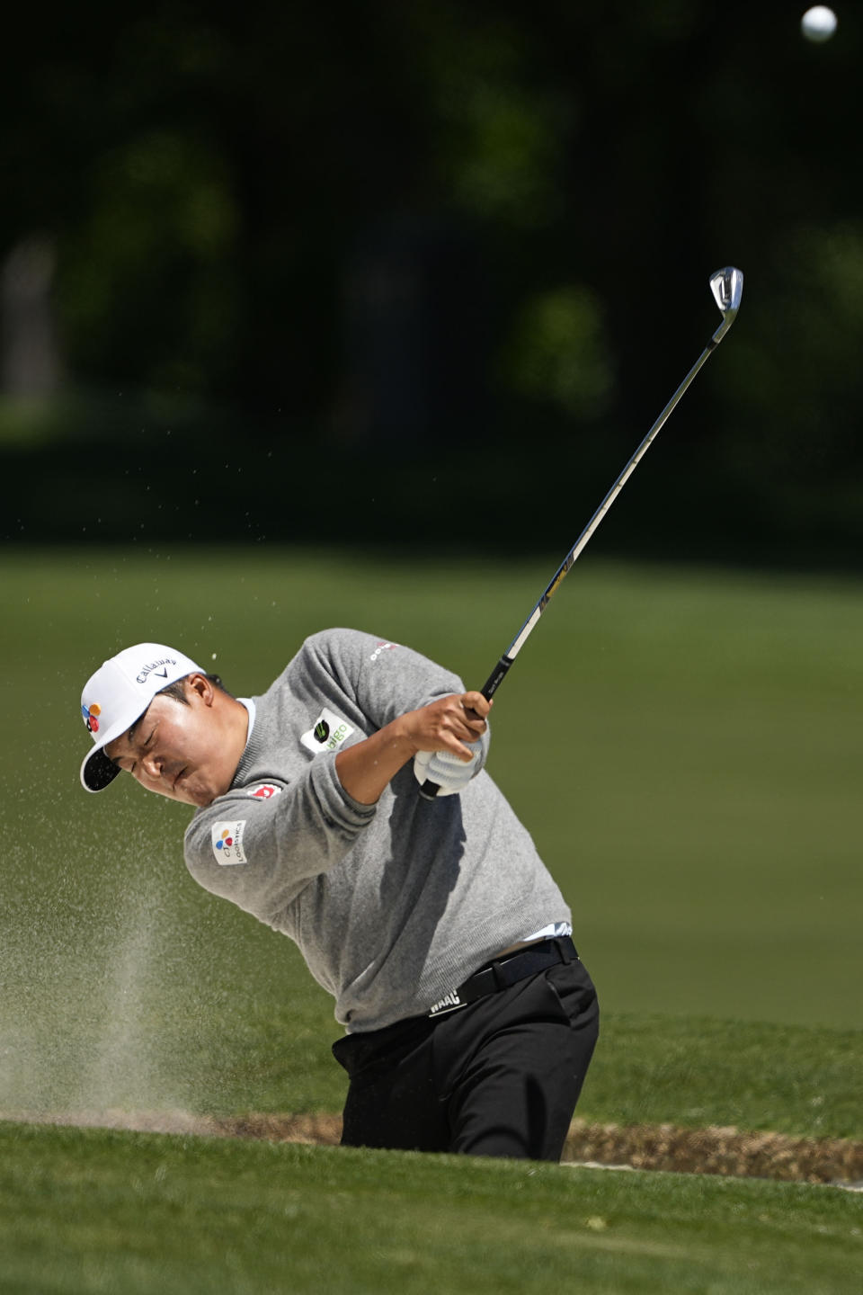 K. H. Lee, of South Korea, hits from the bunker on the 16th hole during first round of the Wells Fargo Championship golf tournament at the Quail Hollow Club on Thursday, May 4, 2023, in Charlotte, N.C. (AP Photo/Chris Carlson)