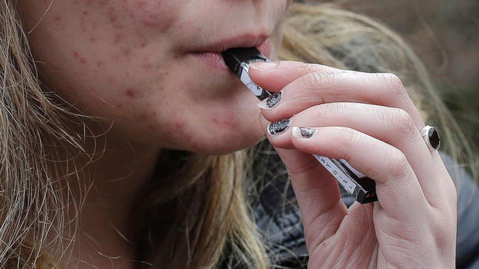 PHOTO: A high school student uses a vaping device near a school campus in Cambridge, Mass., April 11, 2018. (Steven Senne/AP, FILE)