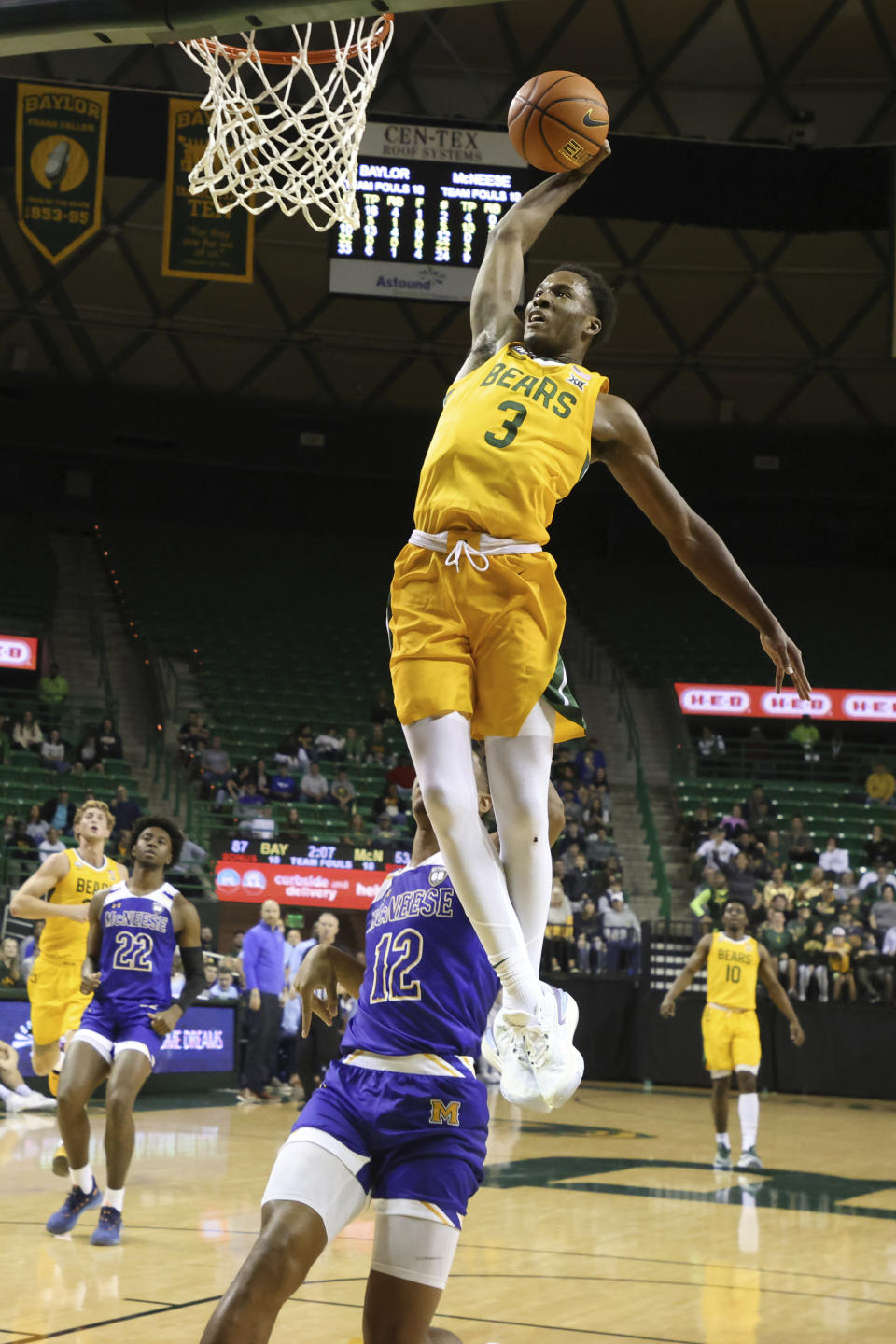 Baylor guard Dale Bonner (3) scores over McNeese State forward Dionjahe Thomas (12) during the second half of an NCAA college basketball game Wednesday, Nov. 23, 2022, in Waco, Texas. (AP Photo/Rod Aydelotte)