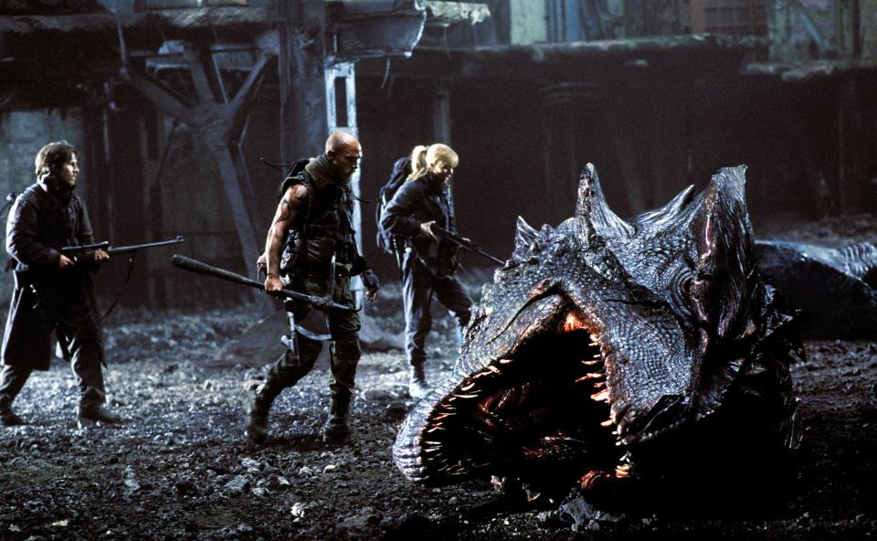 Survivors of a dragon fight search among the wreckage in "Reign of Fire"