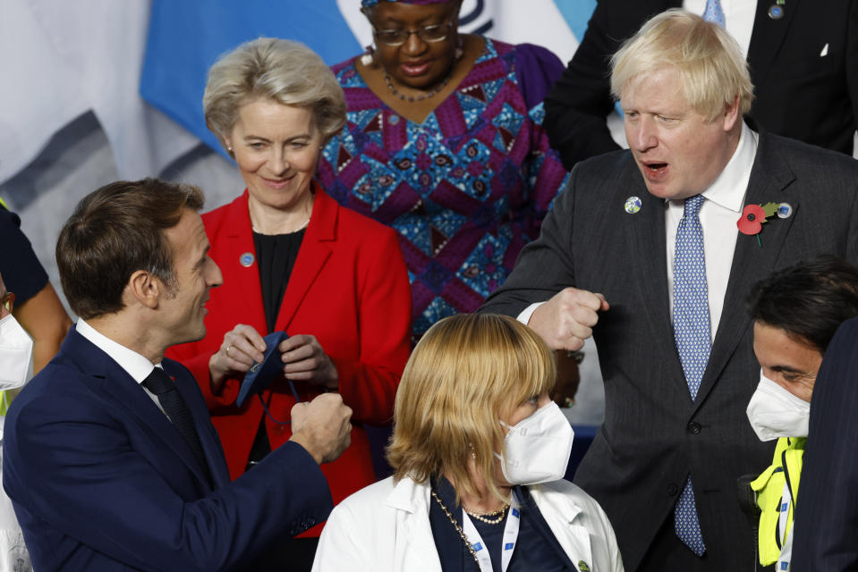 British Prime Minister Boris Johnson, top right, speaks with French President Emmanuel Macron, bottom left, during a group photo at the La Nuvola conference center for the G20 summit in Rome, Saturday, Oct. 30, 2021. The two-day Group of 20 summit is the first in-person gathering of leaders of the world's biggest economies since the COVID-19 pandemic started. (Ludovic Marin, Pool Photo via AP)