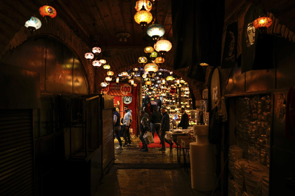 People walk in the Eminonu commercial district, in Istanbul, Turkey, Wednesday, March 20, 2024. (AP Photo/Emrah Gurel)