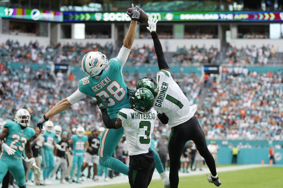 Miami Dolphins tight end Mike Gesicki (88) is unable to grab a pass in the end zone as New York Jets cornerback Sauce Gardner (1) and safety Jordan Whitehead (3) defend during the first half of an NFL football game, Sunday, Jan. 8, 2023, in Miami Gardens, Fla. (AP Photo/Rebecca Blackwell)