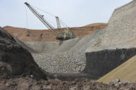 FILE - In this April 4, 2013, file photo, a dragline excavator moves rocks above a coal seam at the Spring Creek Mine in Decker, Mont. The Trump administration is considering using West Coast military bases or other federal properties as transit points for shipments of U.S. coal and natural gas to Asia. (AP Photo/Matthew Brown, File)