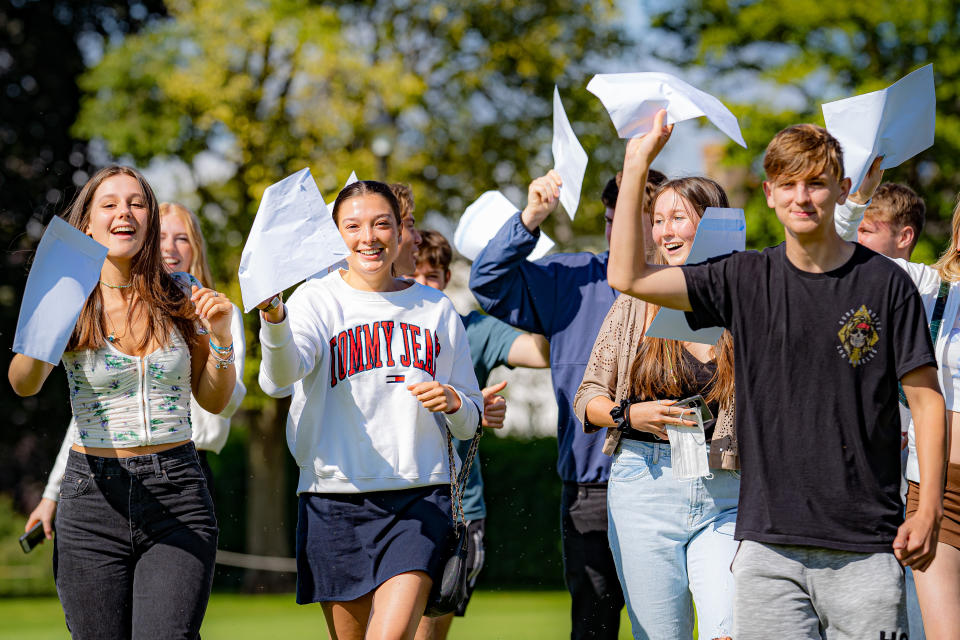 Students wave their A-Level exam results after collecting them at Taunton School in Somerset. Picture date: Tuesday August 10, 2021.