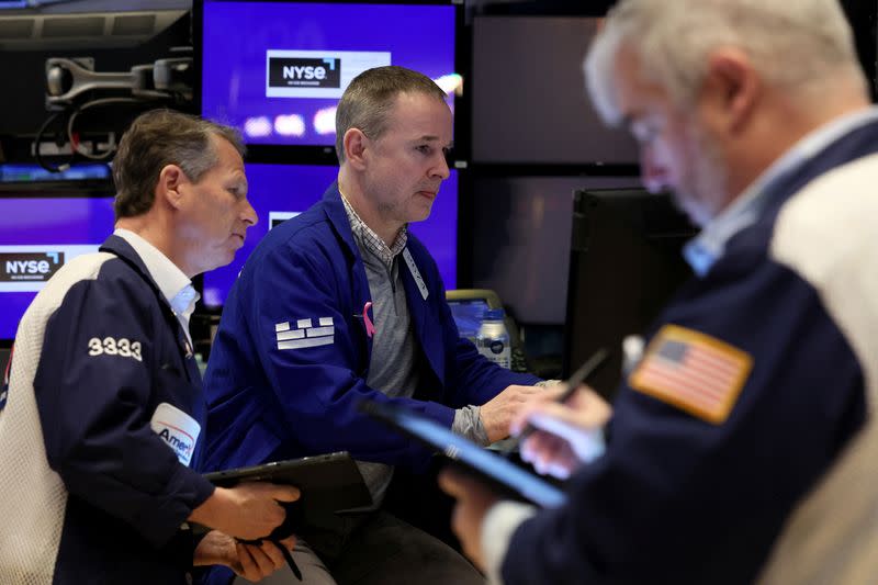 Traders work on the floor of the NYSE in New York