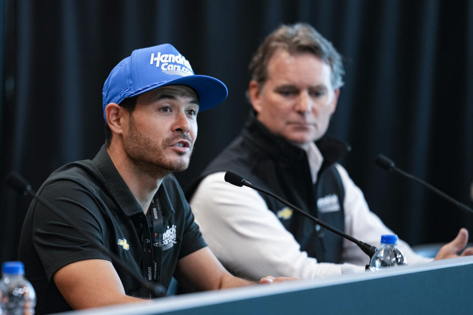 NASCAR's Kyle Larson, left, announces that he will drive for Arrow McLaren in the 2024 Indy 500 auto race during a press conference at Indianapolis Motor Speedway in Indianapolis, Thursday, May 18, 2023. Larson was joined by Jeff Gordon, vice chairman of Hendrick Motorsport, for the announcement. (AP Photo/Michael Conroy)