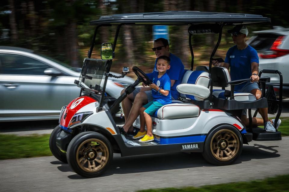 Charlie Maloney test drives his new Mario Bros. themed golf cart with his father Bryan Malone during a Make-A-Wish event at Caloosa Park in Boynton Beach on July 21.
(Credit: THOMAS CORDY/THE PALM BEACH POST)