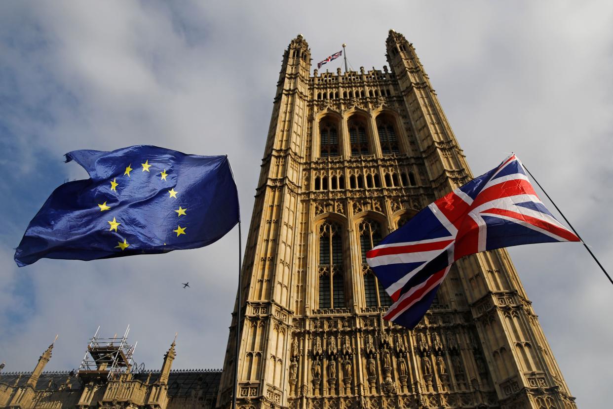 EU and Union flags flutter in the breeze outside the Houses of Parliament in Westminster, central London on October 17, 2019. - Britain's Prime Minister Boris Johnson and the European Union on Thursday reached a provisional agreement that might just see Britain leave the European Union by the October 31 deadline. (Photo by Tolga AKMEN / AFP) (Photo by TOLGA AKMEN/AFP via Getty Images)