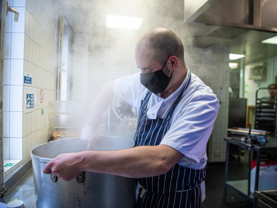 <p>Reporter Vincent Wood pictured during a day volunteering with the team delivering our Help The Hungry campaign</p> (Daniel Hambury/Stella Pictures Ltd)