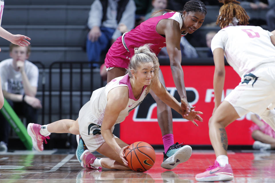 Michigan State's Tory Ozment, left, and Maryland's Diamond Miller vie for the ball during the second half of an NCAA college basketball game, Saturday, Feb. 18, 2023, in East Lansing, Mich. (AP Photo/Al Goldis)