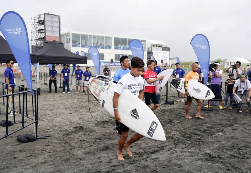 FILE PHOTO: Competitors are seen during a Tokyo 2020 Olympics surfing test event at at Tsurigasaki-kaigan beach, also known as Shidashita beach in Ichinomiya Town, Japan